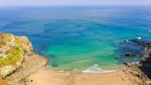 Stunning blue sea and the sand of Trevaunance Cove, St Agnes, Cornwall, UK
